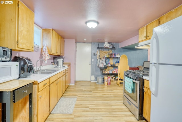 kitchen featuring sink, white appliances, and light hardwood / wood-style flooring