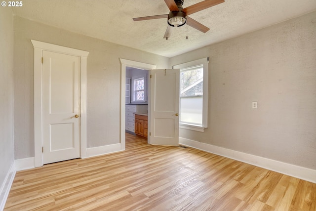 1206 E 9th St, The Dalles, OR 97058 - empty room with baseboards, ceiling fan, a textured ceiling, and light wood-style flooring