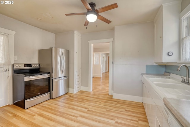 1206 E 9th St, The Dalles, OR 97058 - kitchen with ceiling fan, light wood-style floors, light countertops, stainless steel appliances, and baseboards