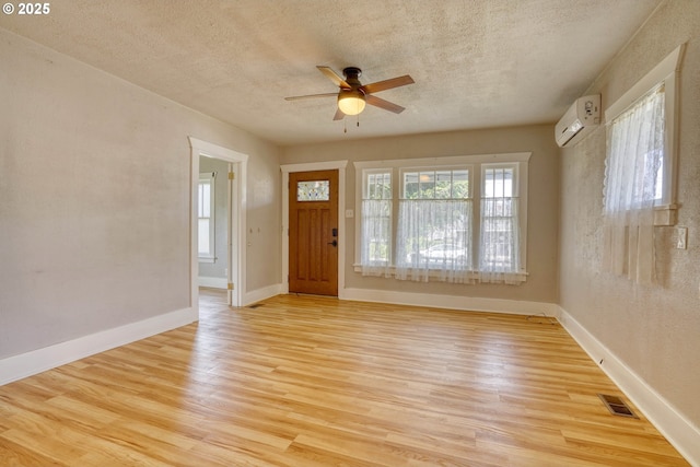 1206 E 9th St, The Dalles, OR 97058 - foyer with an AC wall unit, a textured ceiling, ceiling fan, and light wood finished floors