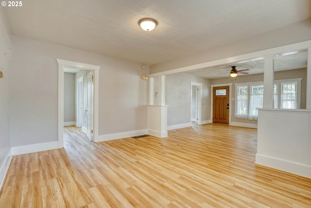1206 E 9th St, The Dalles, OR 97058 - interior space with a ceiling fan, baseboards, a textured ceiling, and light wood-type flooring