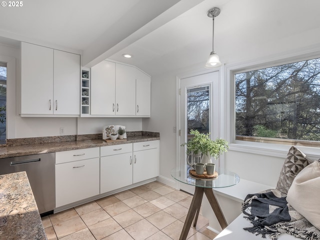 kitchen with white cabinetry, decorative light fixtures, dark stone countertops, light tile patterned floors, and dishwasher