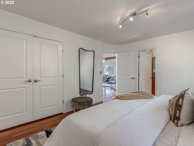 bedroom with wood-type flooring and a closet