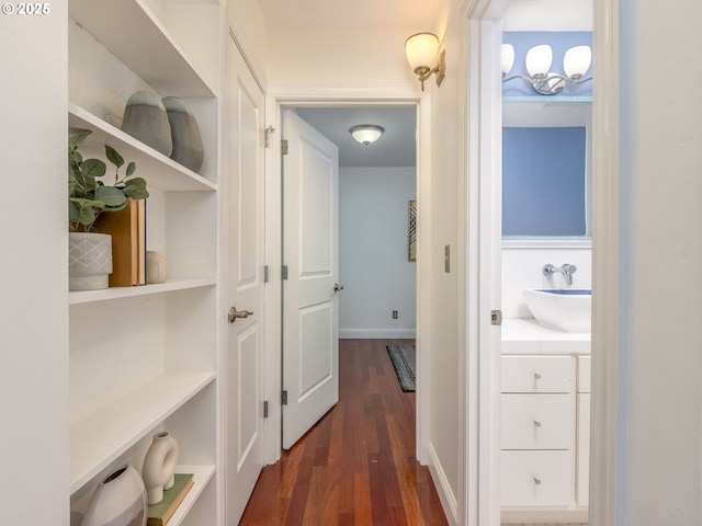 hallway with dark hardwood / wood-style flooring and sink