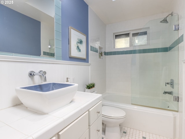 full bathroom featuring vanity, tile patterned flooring, enclosed tub / shower combo, and toilet