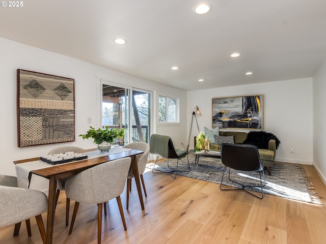 dining space with light hardwood / wood-style floors