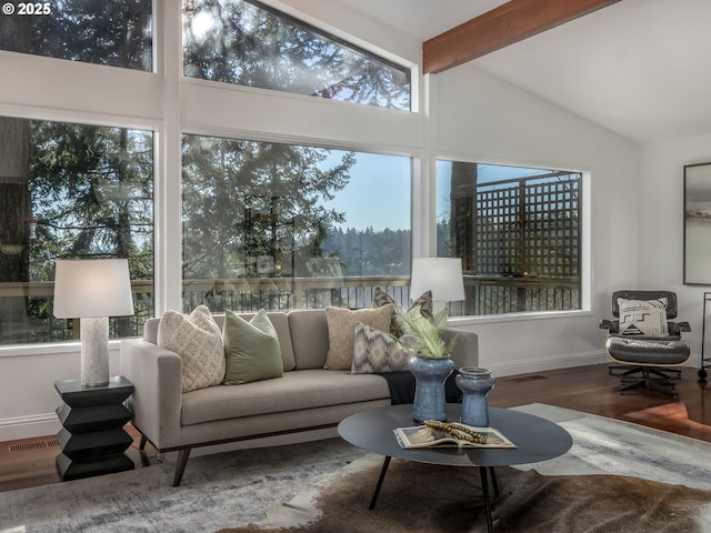 sunroom / solarium with vaulted ceiling with beams