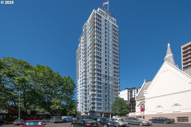 view of building exterior with uncovered parking