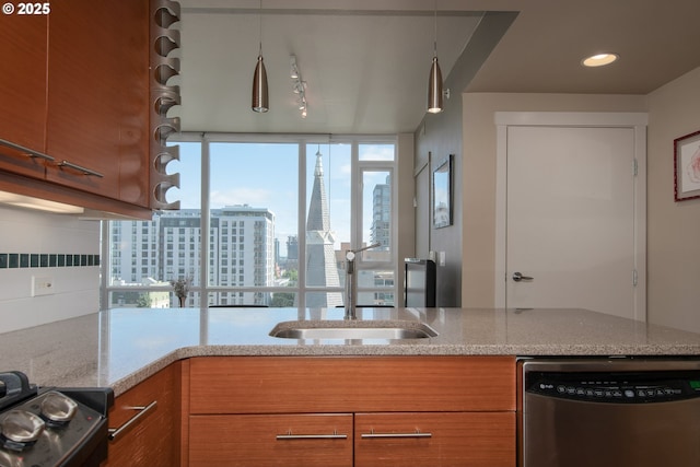 kitchen with brown cabinetry, a sink, a view of city, and stainless steel dishwasher