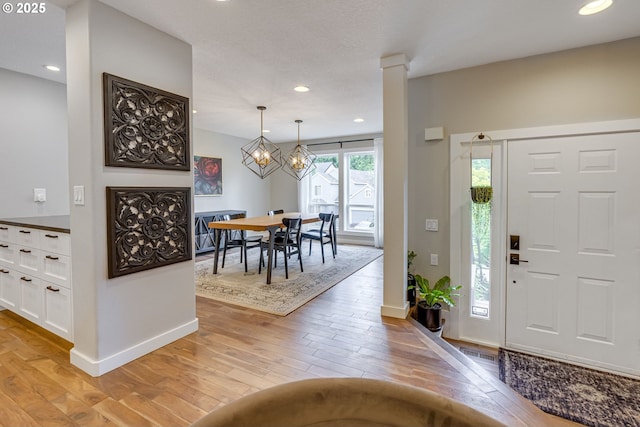 entryway featuring light wood-style floors, baseboards, and recessed lighting