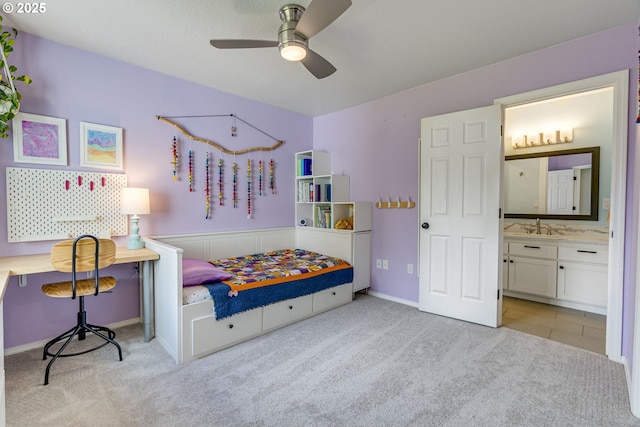 bedroom featuring carpet flooring, connected bathroom, a sink, and ceiling fan