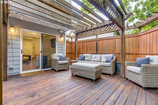 wooden deck featuring an outdoor living space, a pergola, and a fenced backyard