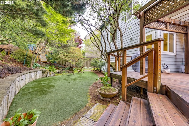 view of yard featuring a deck and a pergola