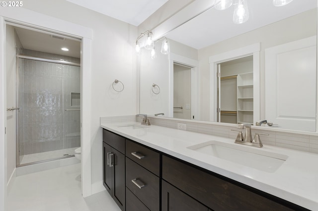 bathroom with vanity, an enclosed shower, and toilet