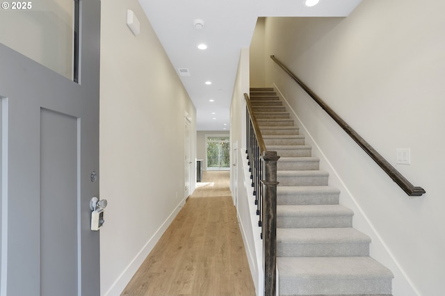 stairway with hardwood / wood-style flooring