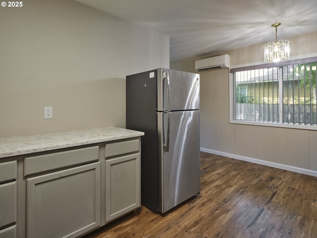 1818 E 32nd St, Vancouver, WA 98663 - kitchen featuring freestanding refrigerator, a wall mounted AC, dark wood-style floors, and a chandelier