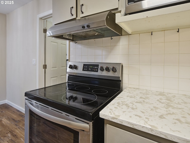 1818 E 32nd St, Vancouver, WA 98663 - kitchen with stainless steel electric range oven, under cabinet range hood, dark wood-type flooring, backsplash, and light countertops