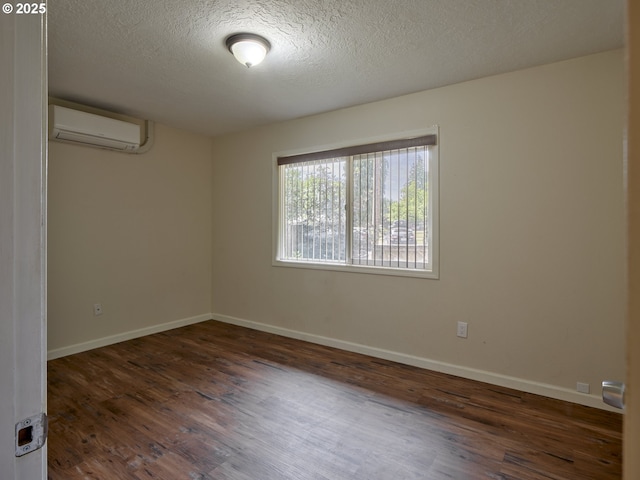 1818 E 32nd St, Vancouver, WA 98663 - empty room with a wall mounted AC, wood finished floors, and a textured ceiling