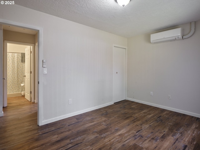 1818 E 32nd St, Vancouver, WA 98663 - spare room featuring a wall mounted air conditioner, dark wood-type flooring, and a textured ceiling