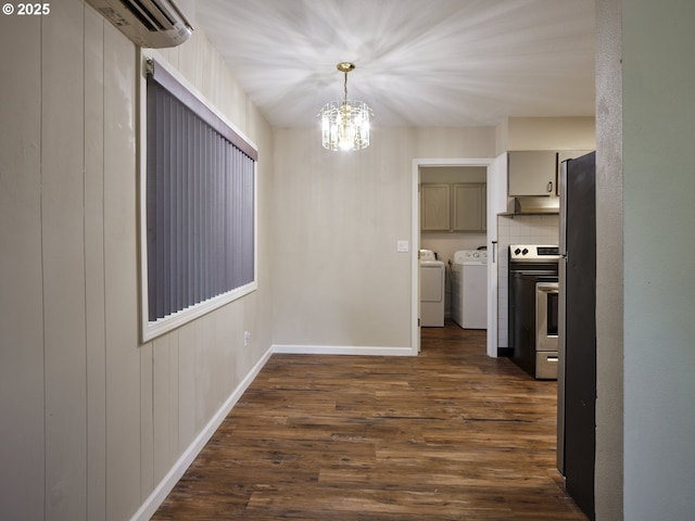 1818 E 32nd St, Vancouver, WA 98663 - unfurnished dining area featuring washing machine and dryer, a chandelier, dark wood-style floors, and a wall mounted air conditioner