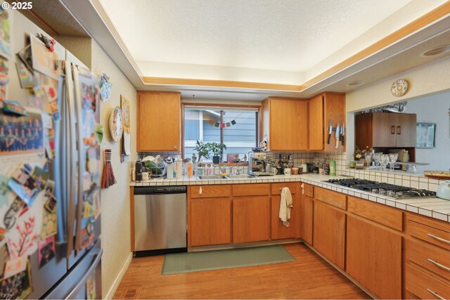 dining space featuring plenty of natural light, light wood-type flooring, and baseboards