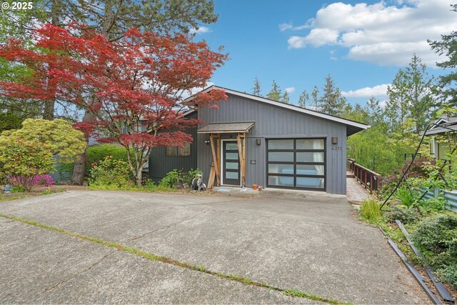 contemporary home with concrete driveway and a garage