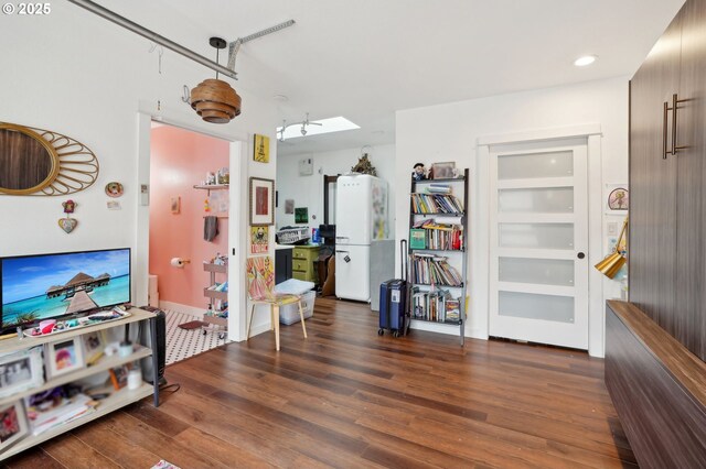 living room with lofted ceiling and wood finished floors