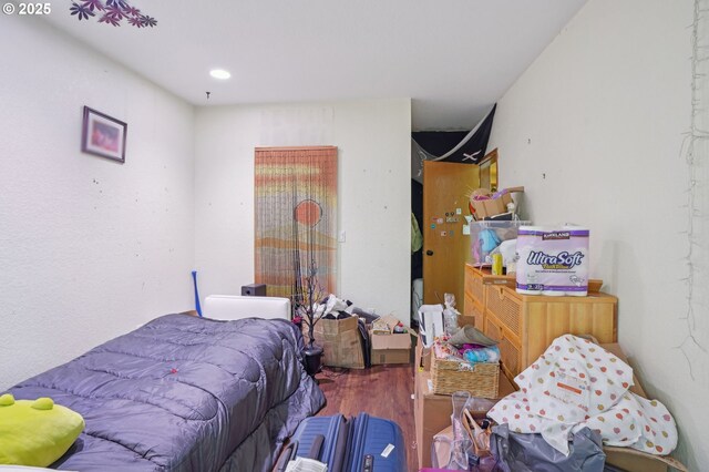 bedroom featuring wood finished floors and recessed lighting