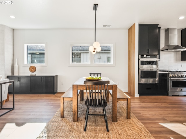 dining room with breakfast area and dark hardwood / wood-style floors