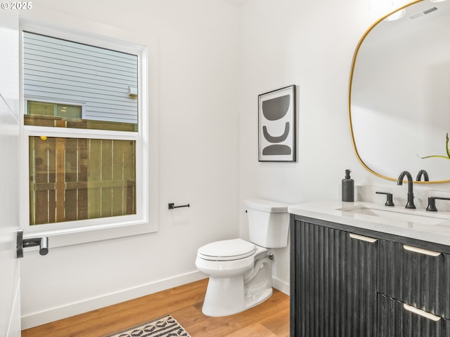 bathroom with vanity, hardwood / wood-style flooring, and toilet