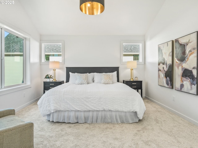 bedroom featuring lofted ceiling and carpet