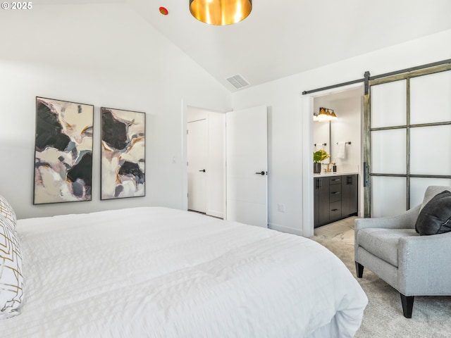 carpeted bedroom featuring lofted ceiling, a barn door, and ensuite bathroom