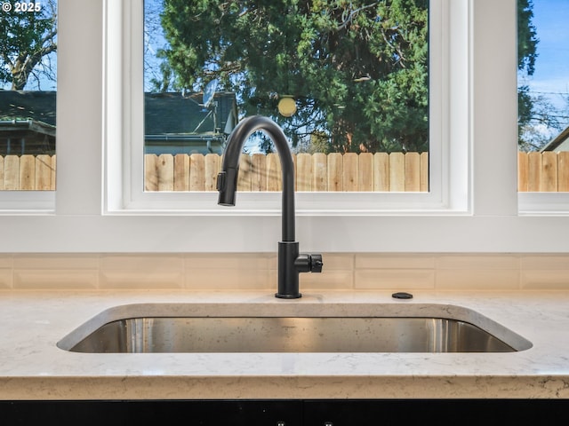 room details featuring light stone counters and sink