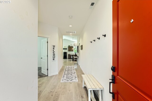 hallway with light wood-style floors and recessed lighting
