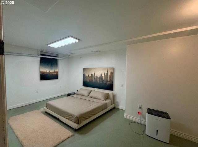 bedroom featuring visible vents, baseboards, and concrete flooring