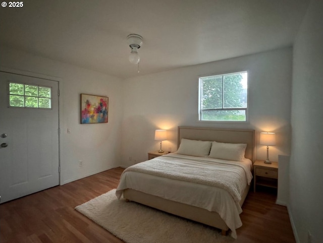 bedroom featuring baseboards and wood finished floors