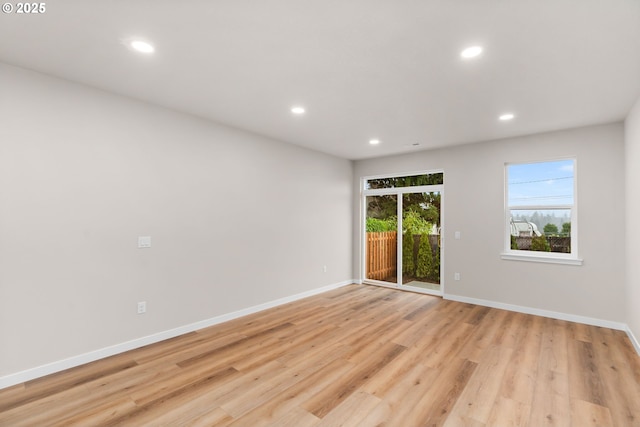 unfurnished room with light wood-type flooring