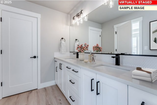 bathroom with vanity and wood-type flooring