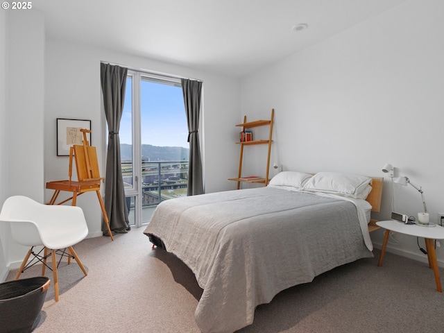 bedroom with carpet floors and a water and mountain view