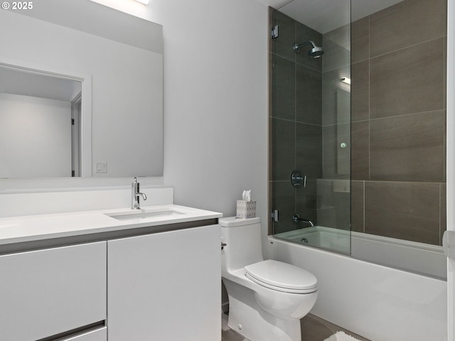 full bathroom with bath / shower combo with glass door, vanity, and toilet