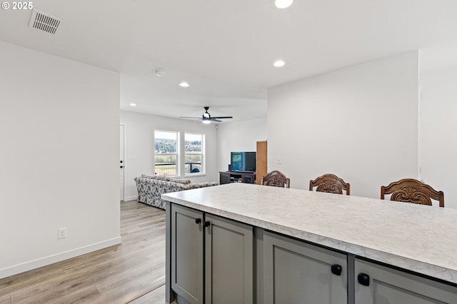 kitchen with visible vents, recessed lighting, gray cabinets, light countertops, and light wood-type flooring