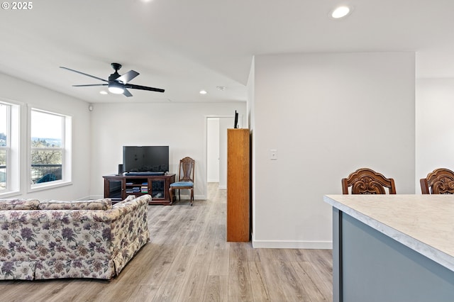 living area with a ceiling fan, light wood-style flooring, recessed lighting, and baseboards