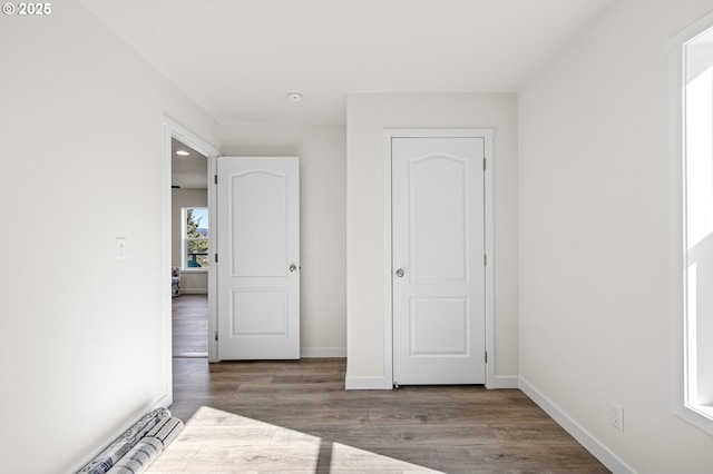 unfurnished bedroom featuring baseboards and wood finished floors