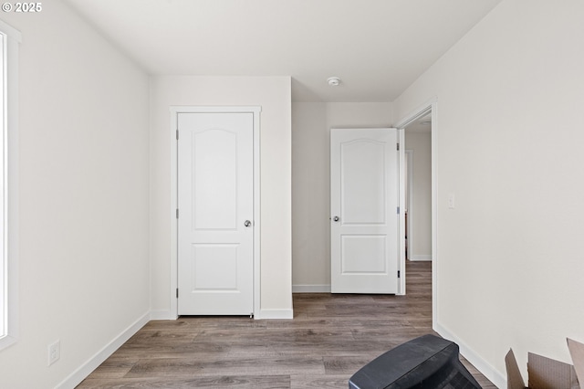 unfurnished bedroom featuring baseboards and wood finished floors