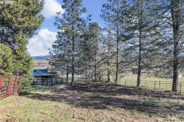 view of yard with an outbuilding and fence