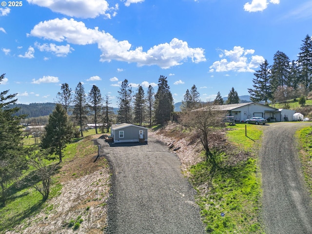 view of street with gravel driveway