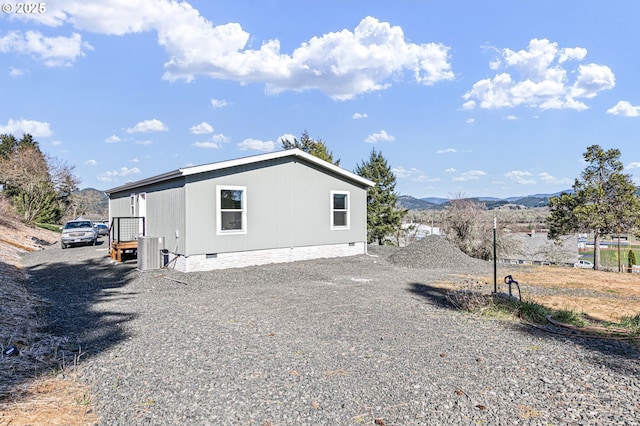 exterior space with crawl space, central air condition unit, and a mountain view