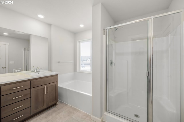 bathroom featuring vanity, tile patterned flooring, and plus walk in shower