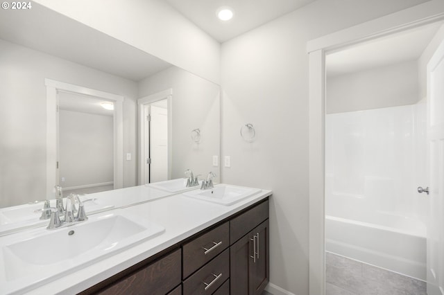 bathroom with tile patterned floors, vanity, and washtub / shower combination