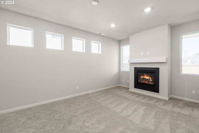 unfurnished living room featuring light colored carpet